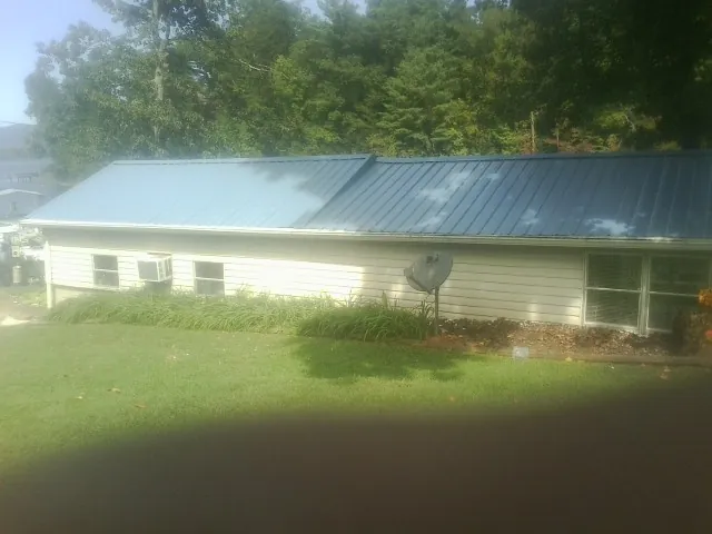 Blue metal roof running the length of a single story home in Elmo